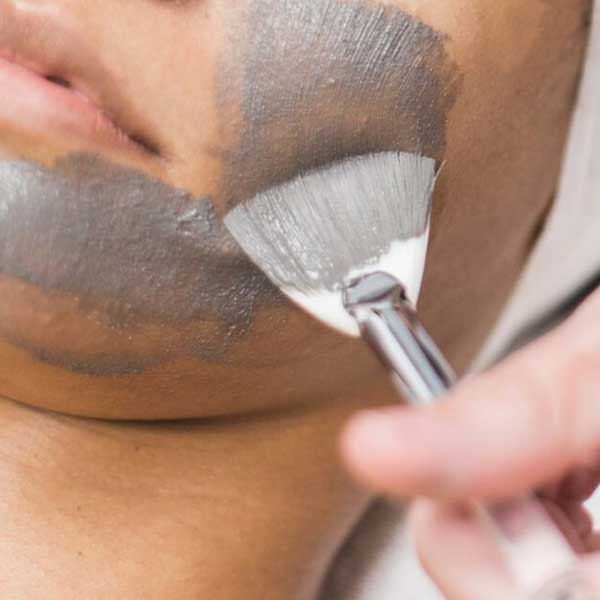brush applying facial paste